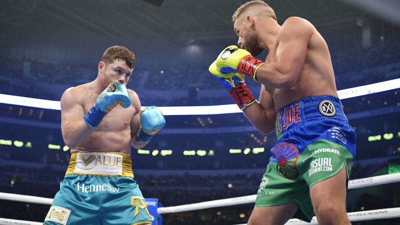 May 8, 2021; Arlington, Texas, USA; Canelo Alvarez (teal trunks) and Billy Joe Saunders (blue green trunks) during a super middleweight boxing title fight at AT&T Stadium. Mandatory Credit: Jerome Miron-USA TODAY Sports