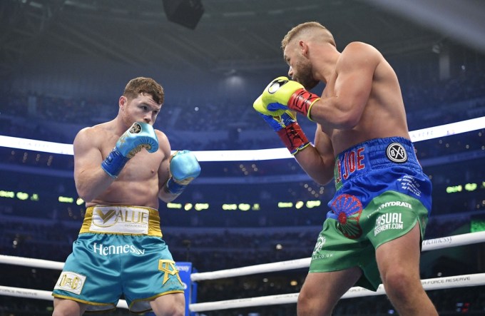 May 8, 2021; Arlington, Texas, USA; Canelo Alvarez (teal trunks) and Billy Joe Saunders (blue green trunks) during a super middleweight boxing title fight at AT&T Stadium. Mandatory Credit: Jerome Miron-USA TODAY Sports