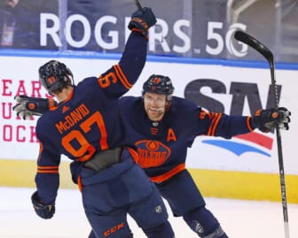 May 8, 2021; Edmonton, Alberta, CAN; Edmonton Oilers forward Connor McDavid (97) celebrates his 100th point of the season on a goal by forward Leon Draisaitl (29) against the Vancouver Canucks at Rogers Place. Mandatory Credit: Perry Nelson-USA TODAY Sports
