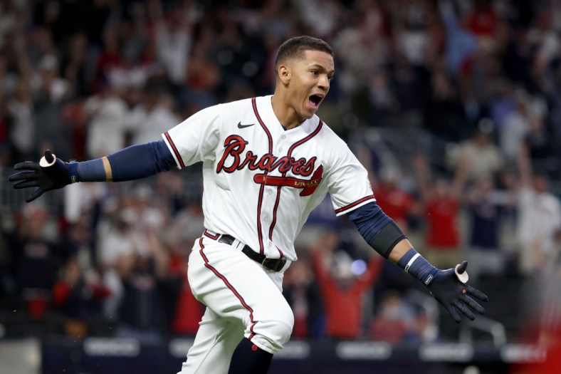 May 8, 2021; Atlanta, Georgia, USA; Atlanta Braves outfielder Ehire Adrianza (23) reacts after hitting the game winning RBI single during the twelfth inning against the Philadelphia Phillies at Truist Park. Mandatory Credit: Jason Getz-USA TODAY Sports