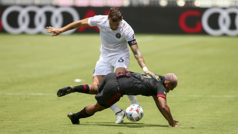 May 9, 2021; Fort Lauderdale, FL, Fort Lauderdale, FL, USA; Atlanta United forward Josef Martinez (7) gets fouled by Inter Miami CF defender Leandro Gonzalez (6) during the first half at DRV PNK Stadium. Mandatory Credit: Sam Navarro-USA TODAY Sports