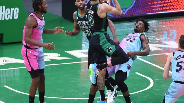 May 9, 2021; Boston, Massachusetts, USA; Boston Celtics forward Jayson Tatum (0) is called for an offensive foul on Miami Heat forward Jimmy Butler (22) during the first half at TD Garden. Mandatory Credit: Bob DeChiara-USA TODAY Sports