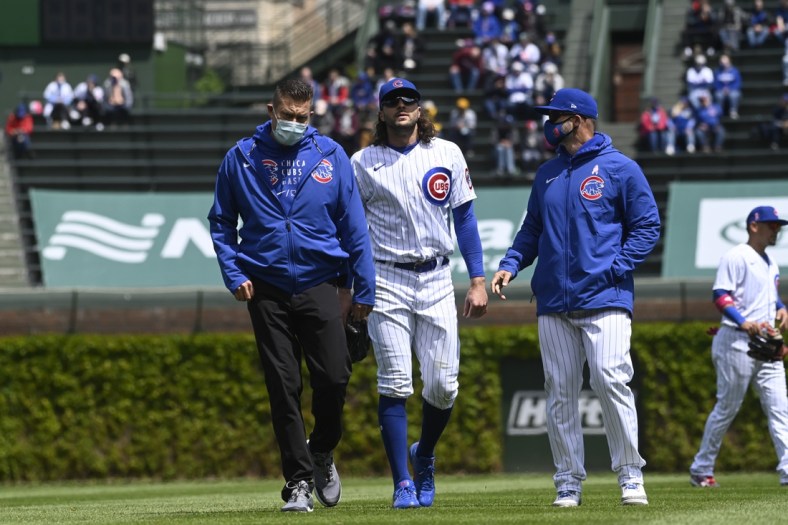 May 9, 2021; Chicago, Illinois, USA;  Chicago Cubs center fielder Jake Marisnick (6) is escorted off the field after Pittsburgh Pirates shortstop Wilmer Difo (15)  hit a two RBI single during the first inning at Wrigley Field. Mandatory Credit: Matt Marton-USA TODAY Sports