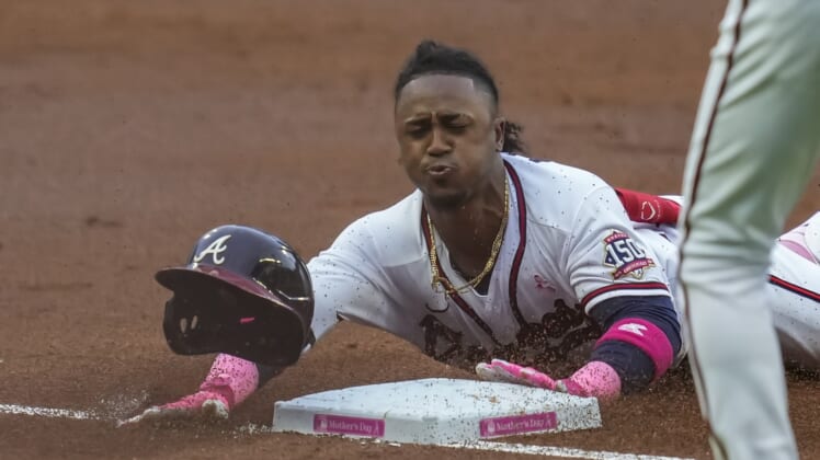 May 9, 2021; Cumberland, Georgia, USA; Atlanta Braves second baseman Ozzie Albies (1) slides into third base after hitting a triple to drive in a run against the Philadelphia Phillies during the first inning at Truist Park. Mandatory Credit: Dale Zanine-USA TODAY Sports