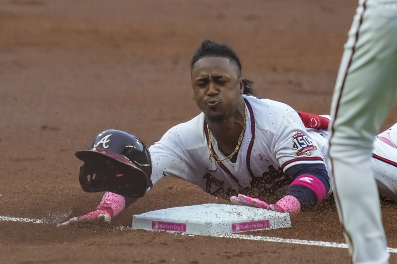 May 9, 2021; Cumberland, Georgia, USA; Atlanta Braves second baseman Ozzie Albies (1) slides into third base after hitting a triple to drive in a run against the Philadelphia Phillies during the first inning at Truist Park. Mandatory Credit: Dale Zanine-USA TODAY Sports