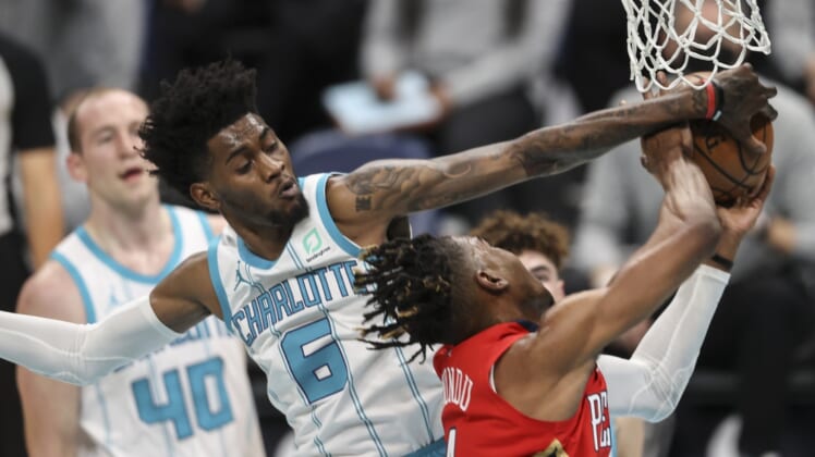 May 9, 2021; Charlotte, North Carolina, USA; Charlotte Hornets forward Jalen McDaniels (6) blocks shot by New Orleans Pelicans forward Wes Iwundu (4) in the second quarter at Spectrum Center. Mandatory Credit: Nell Redmond-USA TODAY Sports