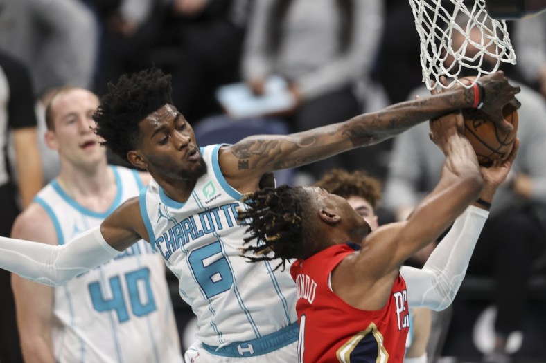May 9, 2021; Charlotte, North Carolina, USA; Charlotte Hornets forward Jalen McDaniels (6) blocks shot by New Orleans Pelicans forward Wes Iwundu (4) in the second quarter at Spectrum Center. Mandatory Credit: Nell Redmond-USA TODAY Sports