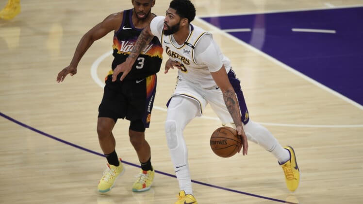 May 9, 2021; Los Angeles, California, USA; Los Angeles Lakers forward Anthony Davis (3) handles the ball while Phoenix Suns guard Chris Paul (3) defends during the second half at Staples Center. Mandatory Credit: Kelvin Kuo-USA TODAY Sports