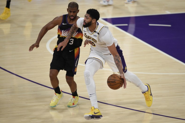 May 9, 2021; Los Angeles, California, USA; Los Angeles Lakers forward Anthony Davis (3) handles the ball while Phoenix Suns guard Chris Paul (3) defends during the second half at Staples Center. Mandatory Credit: Kelvin Kuo-USA TODAY Sports