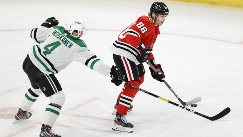 May 10, 2021; Chicago, Illinois, USA; Chicago Blackhawks right wing Patrick Kane (88) looks to pass the puck away from Dallas Stars defenseman Miro Heiskanen (4) during the first period at United Center. Mandatory Credit: Kamil Krzaczynski-USA TODAY Sports