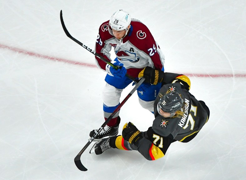 May 10, 2021; Las Vegas, Nevada, USA; Colorado Avalanche center Nathan MacKinnon (29) checks Vegas Golden Knights center William Karlsson (71) off the puck during the second period at T-Mobile Arena. Mandatory Credit: Stephen R. Sylvanie-USA TODAY Sports