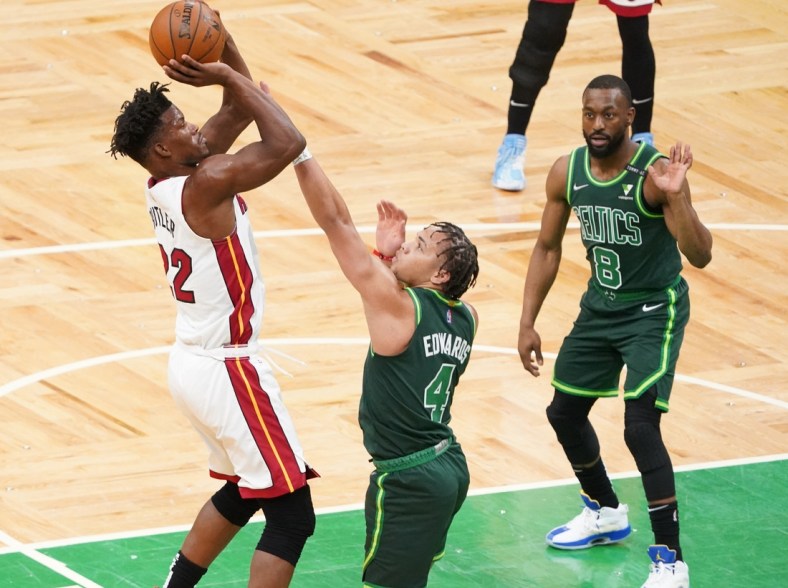 May 11, 2021; Boston, Massachusetts, USA; Miami Heat forward Jimmy Butler (22) scores against Boston Celtics guard Carsen Edwards (4) in the first quarter at TD Garden. Mandatory Credit: David Butler II-USA TODAY Sports