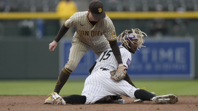 May 11, 2021; Denver, Colorado, USA; Colorado Rockies left fielder Raimel Tapia (15) slides safety under the tag of San Diego Padres second baseman Jake Cronenworth (9) in the first inning at Coors Field. Mandatory Credit: Ron Chenoy-USA TODAY Sports