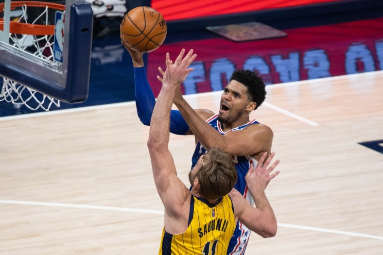 May 11, 2021; Indianapolis, Indiana, USA; Philadelphia 76ers forward Tobias Harris (12) shoots the ball while Indiana Pacers forward Domantas Sabonis (11) defends in the third quarter at Bankers Life Fieldhouse. Mandatory Credit: Trevor Ruszkowski-USA TODAY Sports