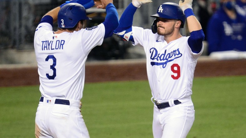 May 11, 2021; Los Angeles, California, USA; Los Angeles Dodgers second baseman Gavin Lux (9) is greeted by center fielder Chris Taylor (3) after hitting a three-run home run against the Seattle Mariners during the eighth inning at Dodger Stadium. Mandatory Credit: Gary A. Vasquez-USA TODAY Sports