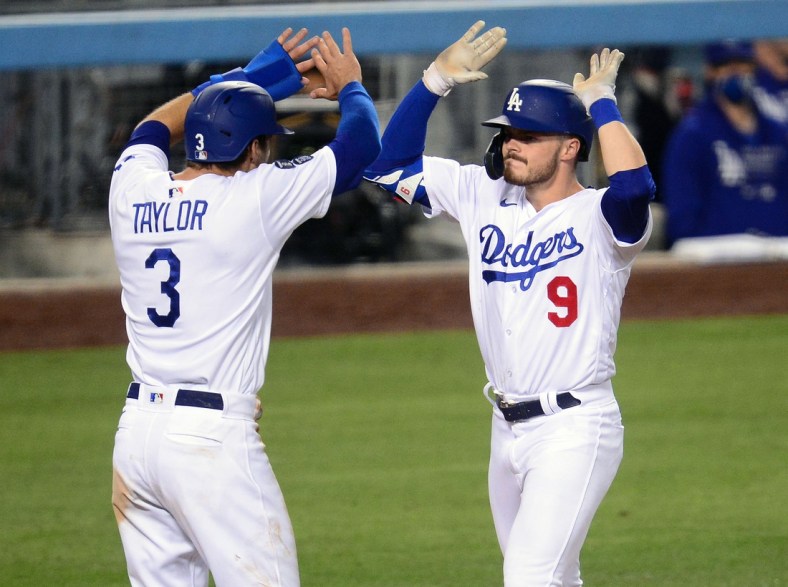 May 11, 2021; Los Angeles, California, USA; Los Angeles Dodgers second baseman Gavin Lux (9) is greeted by center fielder Chris Taylor (3) after hitting a three-run home run against the Seattle Mariners during the eighth inning at Dodger Stadium. Mandatory Credit: Gary A. Vasquez-USA TODAY Sports