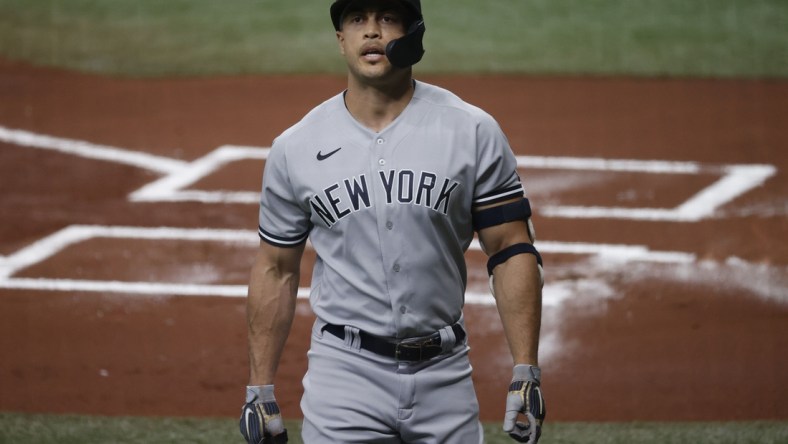 May 12, 2021; St. Petersburg, Florida, USA; New York Yankees designated hitter Giancarlo Stanton (27) strikes out during the first inning against the Tampa Bay Rays at Tropicana Field. Mandatory Credit: Kim Klement-USA TODAY Sports