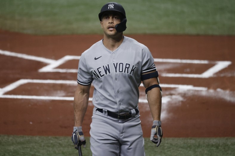 May 12, 2021; St. Petersburg, Florida, USA; New York Yankees designated hitter Giancarlo Stanton (27) strikes out during the first inning against the Tampa Bay Rays at Tropicana Field. Mandatory Credit: Kim Klement-USA TODAY Sports