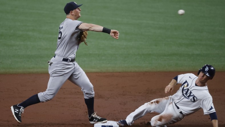 May 12, 2021; St. Petersburg, Florida, USA; New York Yankees second baseman DJ LeMahieu (26) forces out Tampa Bay Rays third baseman Joey Wendle (18) as he throws the ball to first base for a double play during the second inning at Tropicana Field. Mandatory Credit: Kim Klement-USA TODAY Sports