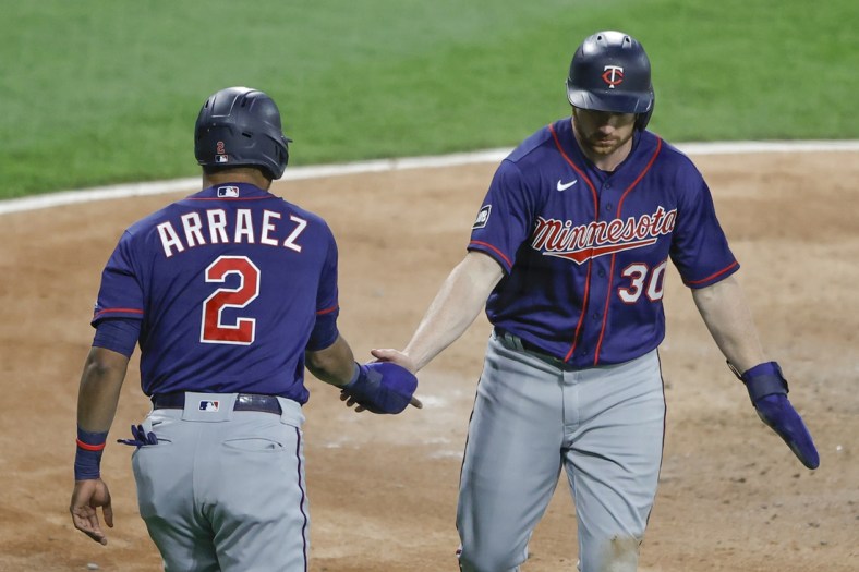 May 12, 2021; Chicago, Illinois, USA; Minnesota Twins left fielder Kyle Garlick (30) celebrates with second baseman Luis Arr  ez (2) after scoring against the Chicago White Sox during the third inning at Guaranteed Rate Field. Mandatory Credit: Kamil Krzaczynski-USA TODAY Sports