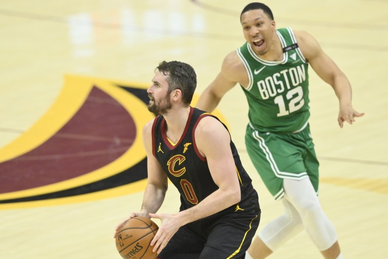 May 12, 2021; Cleveland, Ohio, USA; Cleveland Cavaliers forward Kevin Love (0) looks to shoot a three-point basket beside Boston Celtics forward Grant Williams (12) the third quarter at Rocket Mortgage FieldHouse. Mandatory Credit: David Richard-USA TODAY Sports