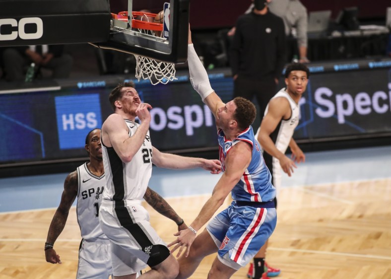 May 12, 2021; Brooklyn, New York, USA; Brooklyn Nets forward Blake Griffin (2) dunks past San Antonio Spurs center Jakob Poeltl (25) in the third quarter against the San Antonio Spurs at Barclays Center. Mandatory Credit: Wendell Cruz-USA TODAY Sports