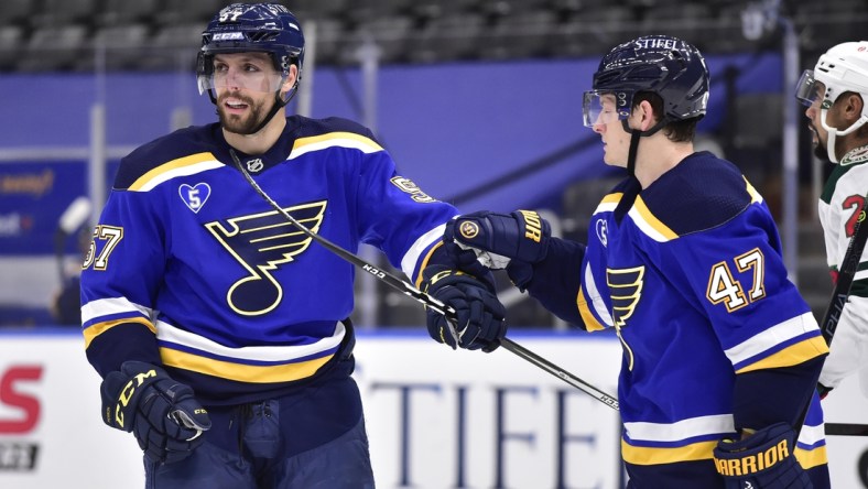 May 12, 2021; St. Louis, Missouri, USA;  St. Louis Blues left wing David Perron (57) is congratulated by defenseman Torey Krug (47) after scoring during the second period against the Minnesota Wild at Enterprise Center. Mandatory Credit: Jeff Curry-USA TODAY Sports