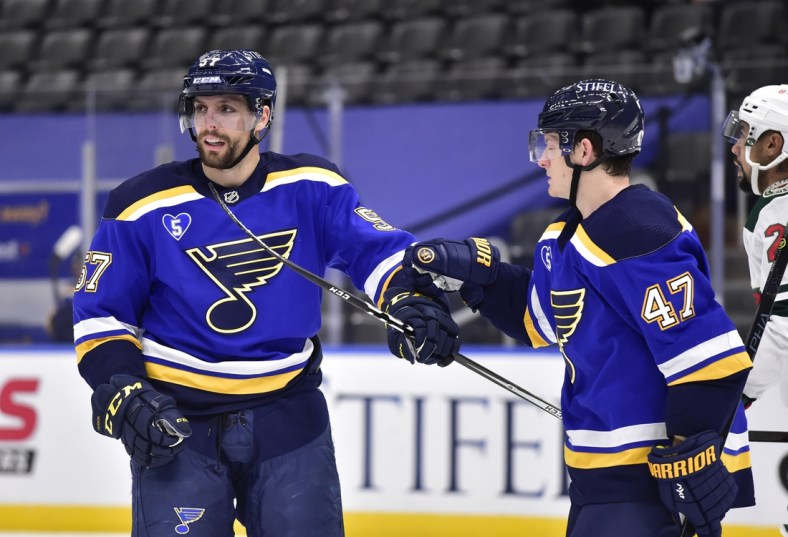 May 12, 2021; St. Louis, Missouri, USA;  St. Louis Blues left wing David Perron (57) is congratulated by defenseman Torey Krug (47) after scoring during the second period against the Minnesota Wild at Enterprise Center. Mandatory Credit: Jeff Curry-USA TODAY Sports