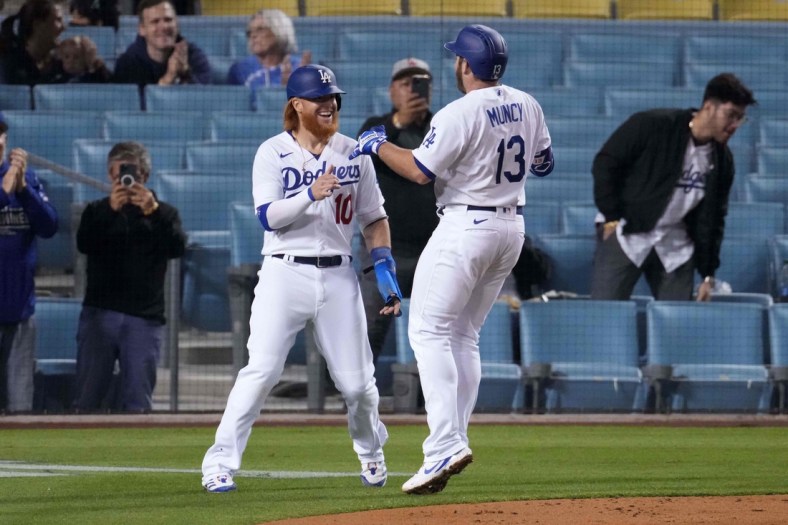 May 12, 2021; Los Angeles, California, USA; Los Angeles Dodgers first baseman Max Muncy (13) celebrates with third baseman Justin Turner (10) after hitting a two-run home run during the fifth inning against the Seattle Mariners at Dodger Stadium. Mandatory Credit: Kirby Lee-USA TODAY Sports