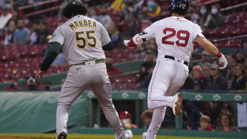 May 13, 2021; Boston, Massachusetts, USA; Boston Red Sox third baseman Bobby Dalbec (29) is called safe at first base against Oakland Athletics starting pitcher Sean Manaea (55) during the third inning at Fenway Park. Mandatory Credit: David Butler II-USA TODAY Sports