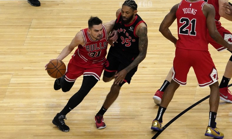 May 13, 2021; Chicago, Illinois, USA; Chicago Bulls guard Tomas Satoransky (31) is defended by Toronto Raptors guard DeAndre' Bembry (95) during the first half at United Center. Mandatory Credit: David Banks-USA TODAY Sports