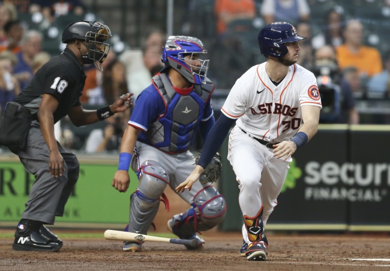 May 13, 2021; Houston, Texas, USA; Houston Astros left fielder Kyle Tucker (30) with a base hit against the Texas Rangers in the second inning at Minute Maid Park. Mandatory Credit: Thomas Shea-USA TODAY Sports