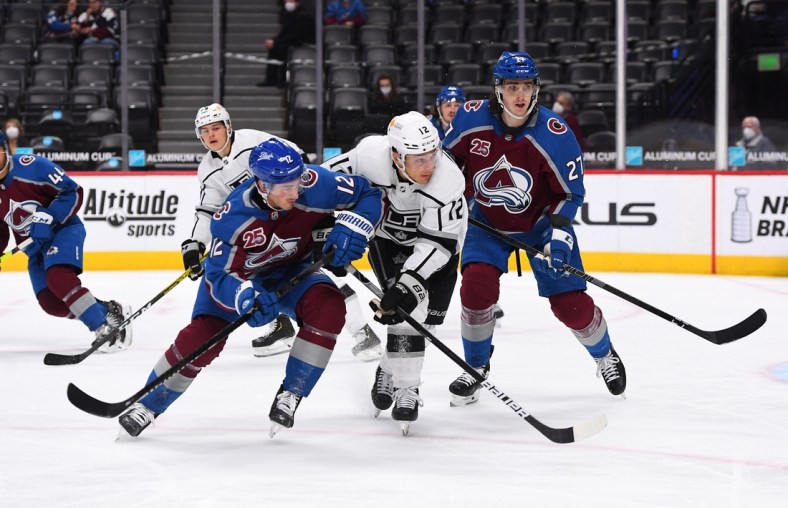 May 13, 2021; Denver, Colorado, USA; Colorado Avalanche center Jayson Megna (12) and Los Angeles Kings center Trevor Moore (12) and defenseman Ryan Graves (27) during the first period at Ball Arena. Mandatory Credit: Ron Chenoy-USA TODAY Sports