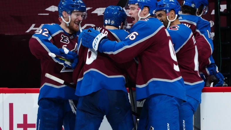 May 13, 2021; Denver, Colorado, USA; Colorado Avalanche left wing Gabriel Landeskog (92) and defenseman Cale Makar (8) and right wing Mikko Rantanen (96) and right wing Mikko Rantanen (96) and center Pierre-Edouard Bellemare (41) celebrate defeating the Los Angeles Kings at Ball Arena. Mandatory Credit: Ron Chenoy-USA TODAY Sports