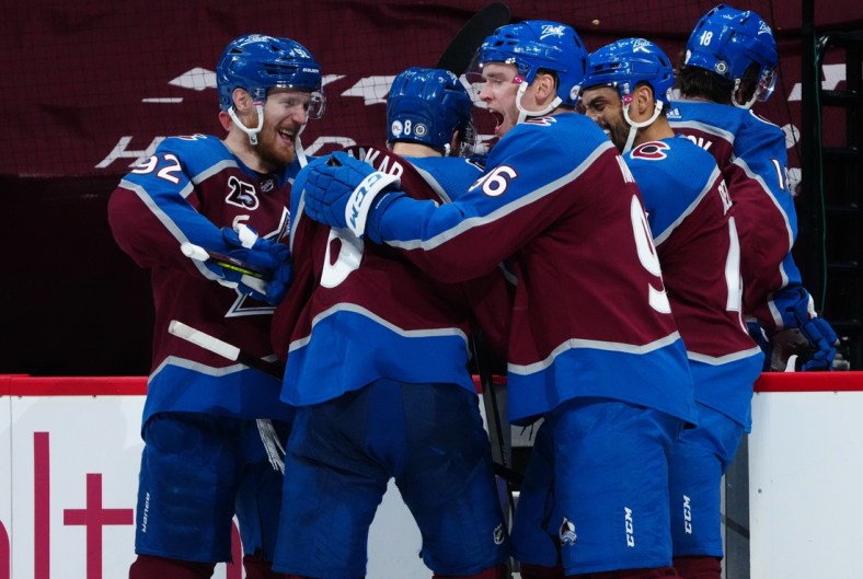 May 13, 2021; Denver, Colorado, USA; Colorado Avalanche left wing Gabriel Landeskog (92) and defenseman Cale Makar (8) and right wing Mikko Rantanen (96) and right wing Mikko Rantanen (96) and center Pierre-Edouard Bellemare (41) celebrate defeating the Los Angeles Kings at Ball Arena. Mandatory Credit: Ron Chenoy-USA TODAY Sports