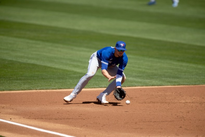 May 6, 2021; Oakland, California, USA; Toronto Blue Jays third baseman Cavan Biggio fields a ground ball by Oakland Athletics right fielder Stephen Piscotty during the second inning at RingCentral Coliseum. Mandatory Credit: D. Ross Cameron-USA TODAY Sports