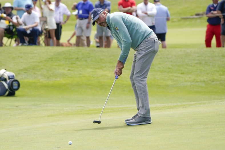 May 14, 2021; McKinney, Texas, USA; Matt Kuchar putts on the 18th green during the second round of the AT&T Byron Nelson golf tournament. Mandatory Credit: Jim Cowsert-USA TODAY Sports