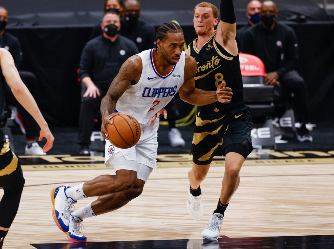 May 11, 2021; Tampa, Florida, USA;  LA Clippers forward Kawhi Leonard (2) drives the lane past Toronto Raptors guard Malachi Flynn (8) in the first quarter at Amalie Arena. Mandatory Credit: Nathan Ray Seebeck-USA TODAY Sports