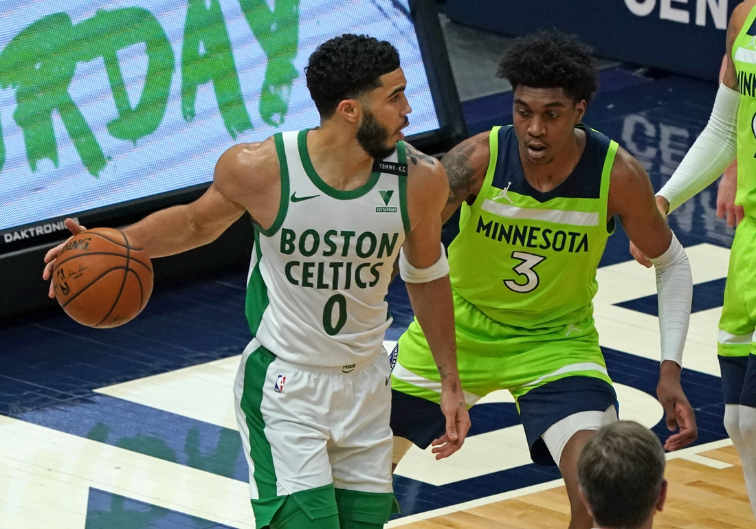 May 15, 2021; Minneapolis, Minnesota, USA;  Boston Celtics forward Jayson Tatum (0) controls the ball as Minnesota Timberwolves forward Jaden McDaniels (3) defends during the first quarter at Target Center. Mandatory Credit: Nick Wosika-USA TODAY Sports