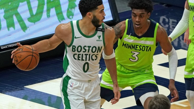 May 15, 2021; Minneapolis, Minnesota, USA;  Boston Celtics forward Jayson Tatum (0) controls the ball as Minnesota Timberwolves forward Jaden McDaniels (3) defends during the first quarter at Target Center. Mandatory Credit: Nick Wosika-USA TODAY Sports