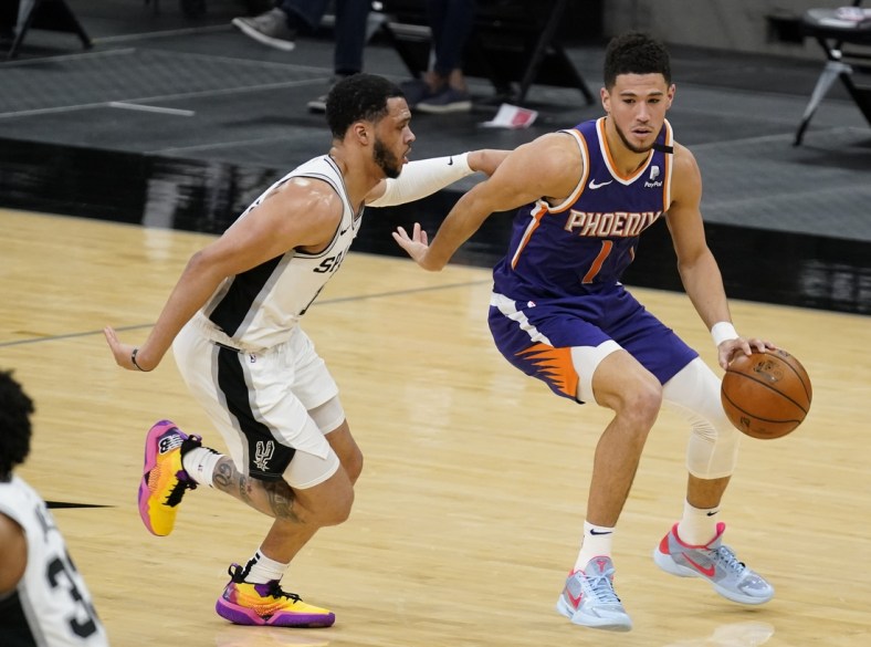 May 15, 2021; San Antonio, Texas, USA; Phoenix Suns guard Devin Booker (1) dribbles up court as San Antonio Spurs guard Quinndary Weatherspoon (15) defends in the second quarter at AT&T Center. Mandatory Credit: Scott Wachter-USA TODAY Sports