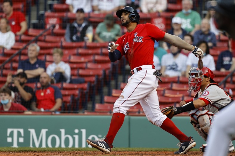 May 15, 2021; Boston, Massachusetts, USA; Boston Red Sox shortstop Xander Bogaerts (2) follows through on his three-run home run against the Los Angeles Angels during the fifth inning at Fenway Park. Mandatory Credit: Winslow Townson-USA TODAY Sports