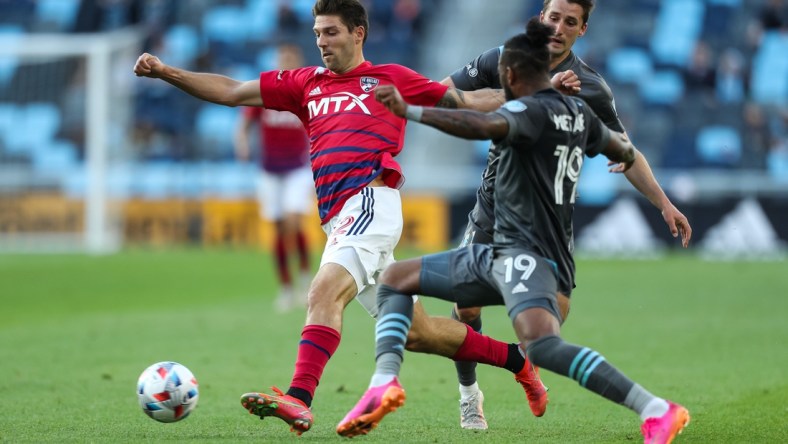 May 15, 2021; Saint Paul, MN, Saint Paul, MN, USA; FC Dallas midfielder Ryan Hollingshead (12) and Minnesota United defender Romain Metanire (19) compete for the ball i the first half at Allianz Field. Mandatory Credit: David Berding-USA TODAY Sports