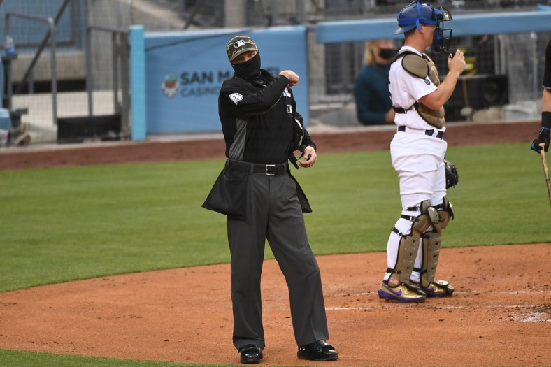 May 15, 2021; Los Angeles, California, USA; HP umpire Chad Fairchild (4) ejects Miami Marlins hitting coach Eric Duncan in the second inning against the Los Angeles Dodgers at Dodger Stadium. Mandatory Credit: Richard Mackson-USA TODAY Sports