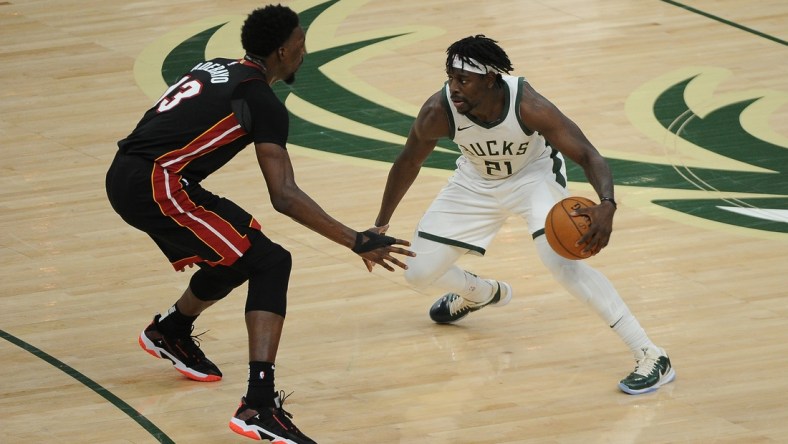 May 15, 2021; Milwaukee, Wisconsin, USA;  Miami Heat center Bam Adebayo (13) guards Milwaukee Bucks guard Jrue Holiday (21) in the third quarter at Fiserv Forum. Mandatory Credit: Michael McLoone-USA TODAY Sports