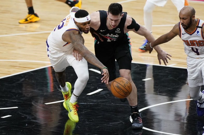 May 16, 2021; San Antonio, Texas, USA; Phoenix Suns forward Torrey Craig (12) and San Antonio Spurs forward Drew Eubanks (14) go after loose ball in the fourth quarter at AT&T Center. Mandatory Credit: Scott Wachter-USA TODAY Sports