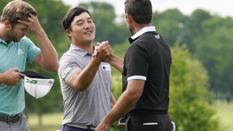 May 16, 2021; McKinney, Texas, USA; K.H. Lee is congratulated by Charl Schwartzel for his tournament win during the final round of the AT&T Byron Nelson golf tournament. Mandatory Credit: Jim Cowsert-USA TODAY Sports