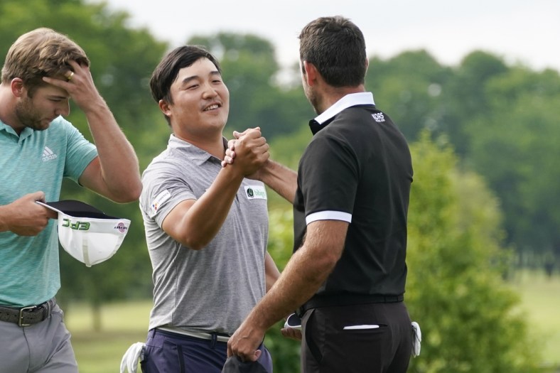 May 16, 2021; McKinney, Texas, USA; K.H. Lee is congratulated by Charl Schwartzel for his tournament win during the final round of the AT&T Byron Nelson golf tournament. Mandatory Credit: Jim Cowsert-USA TODAY Sports