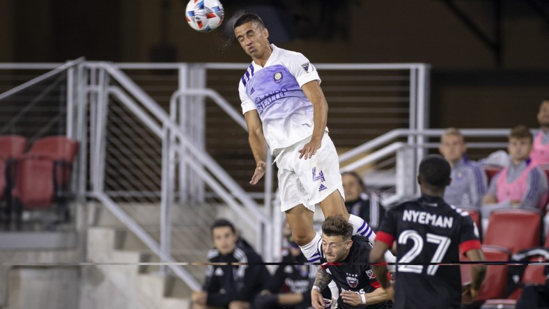 May 16, 2021; Washington, DC, USA; Orlando City defender Joao Moutinho (4) heads the ball against D.C. United during the first half of the match at Audi Field. Mandatory Credit: Scott Taetsch-USA TODAY Sports