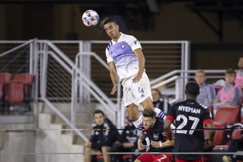 May 16, 2021; Washington, DC, USA; Orlando City defender Joao Moutinho (4) heads the ball against D.C. United during the first half of the match at Audi Field. Mandatory Credit: Scott Taetsch-USA TODAY Sports